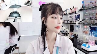 lab__ -Asian girl at work teasing on camera and sweet-talking.