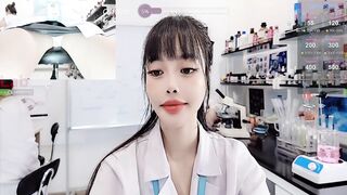 lab__ -Asian girl at work teasing on camera and sweet-talking.