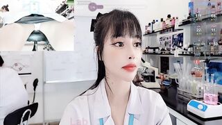 lab__ -Asian girl at work teasing on camera and sweet-talking.